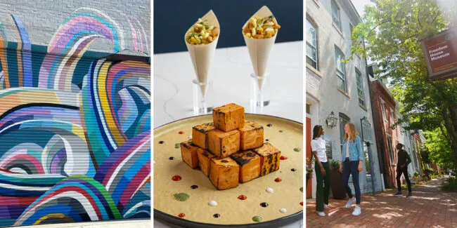 A colorful abstract mural, a plate of grilled paneer cubes with sauces and two cone-shaped appetizers, and people walking along a historic brick street with trees and a museum sign.