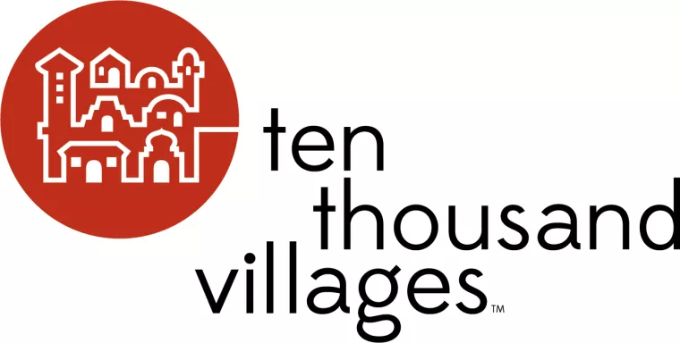 Logo for Ten Thousand Villages with a red circle featuring a white line drawing of village buildings on the left, and the words ten thousand villages in lowercase black letters on the right.
