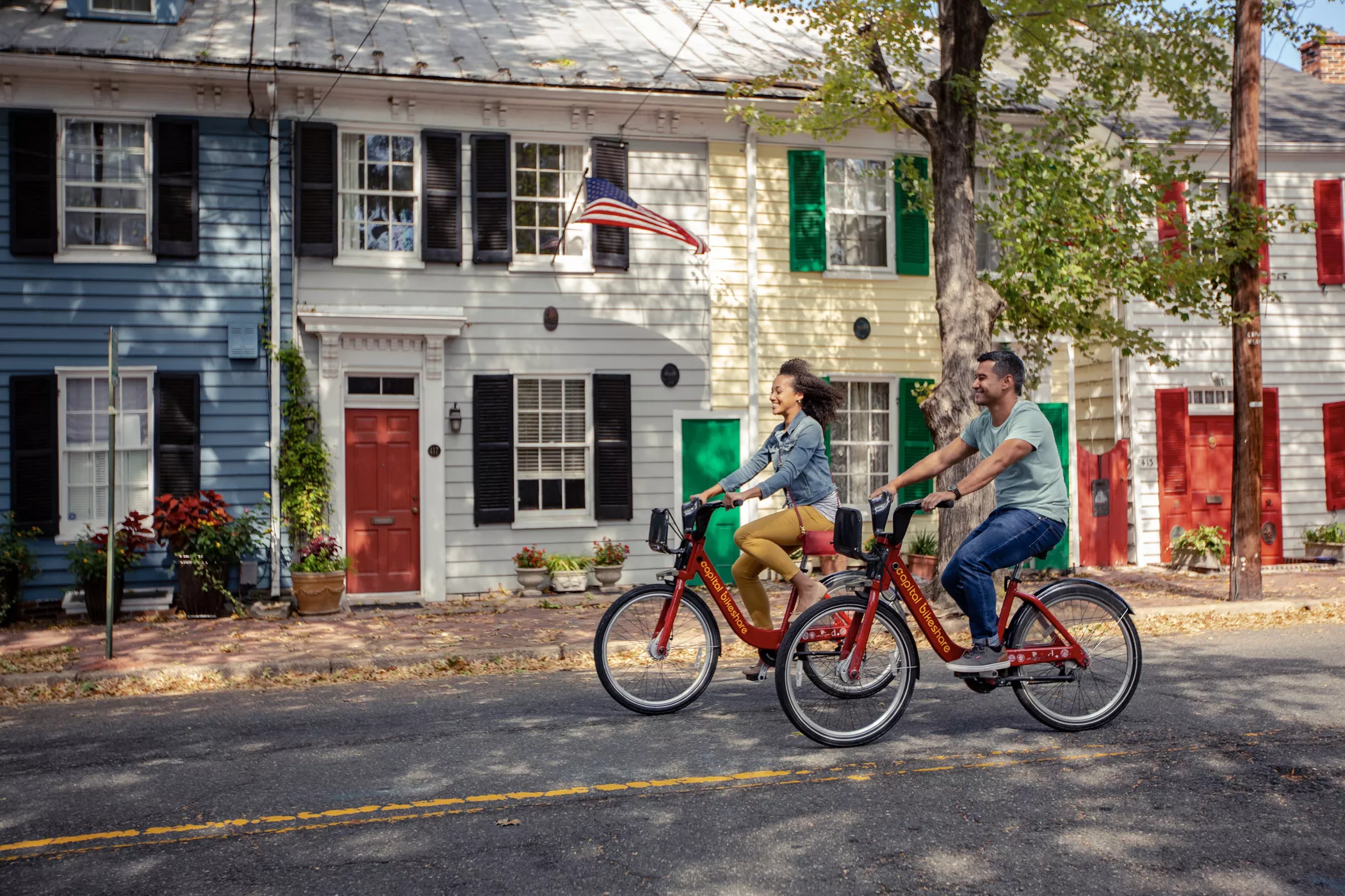 Couple Biking Down King Street In Alexandria, VA