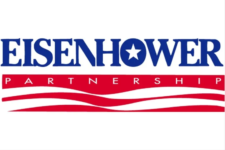 Logo with the word Eisenhower in blue, with a star inside the O. Below, a red banner with Partnership in white letters, over red and white wavy lines. The background is white.