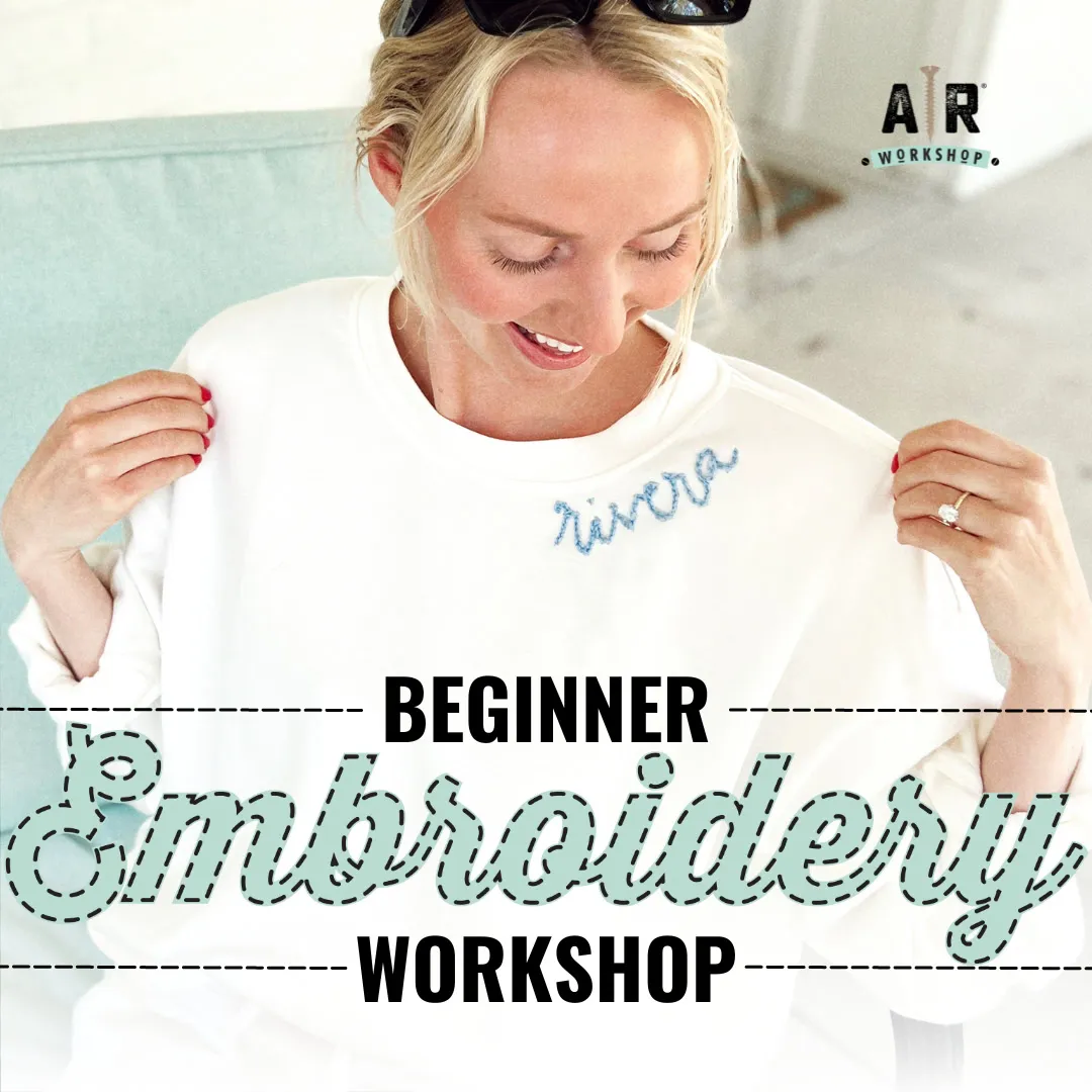 A smiling woman looks down at “rivera” embroidered on her white shirt. Text reads: Beginner Embroidery Workshop. The AR Workshop logo is in the top right corner.