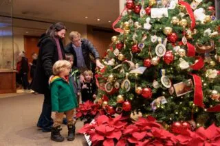 A family admires a Christmas tree at Mount Vernon in Alexandria, VA.