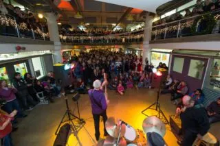 Spectators watch a live band perform inside the Torpedo Art Center as part of Alexandria's First Night festivities.