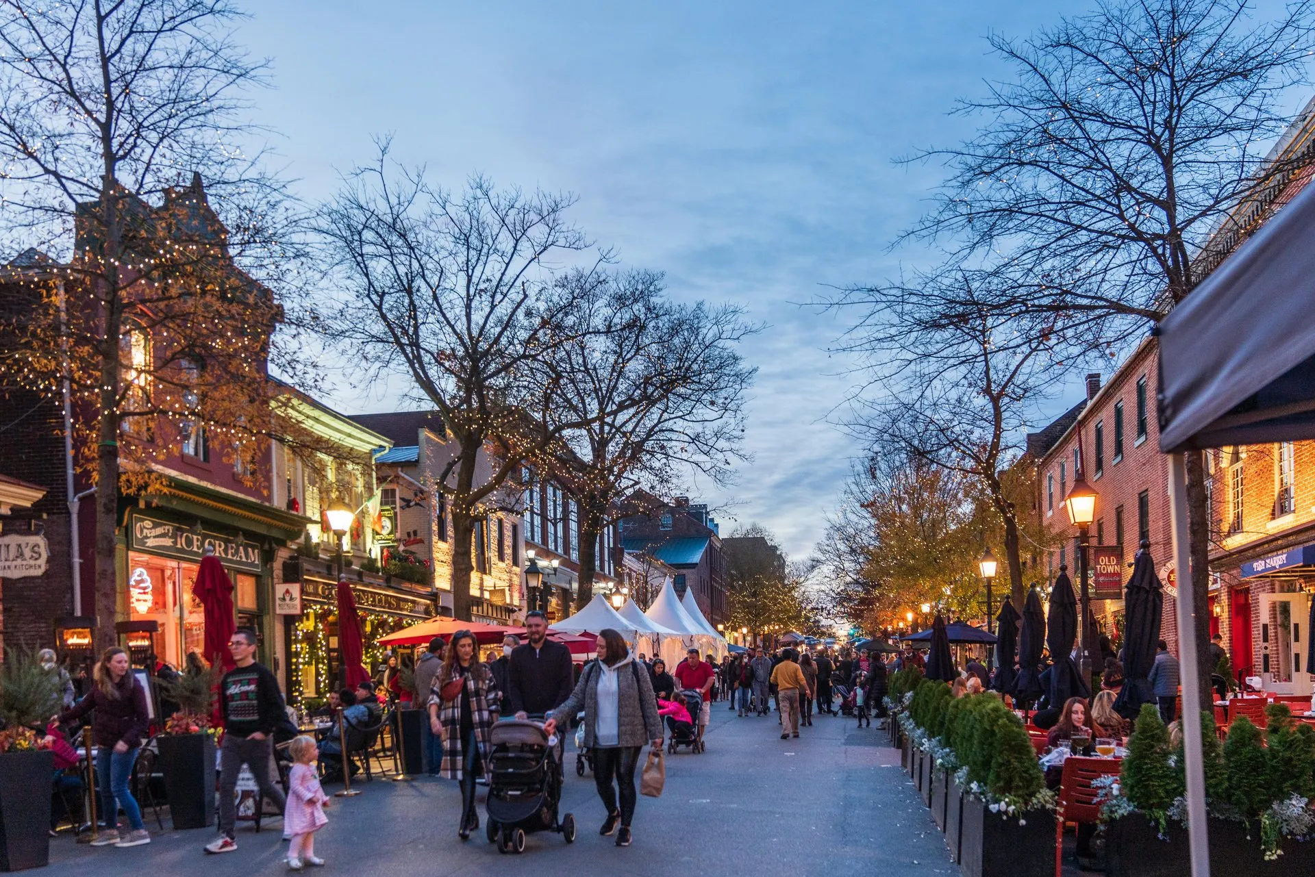 Visitors walk down King Street in Old Town Alexandria, VA during the winter holiday season.