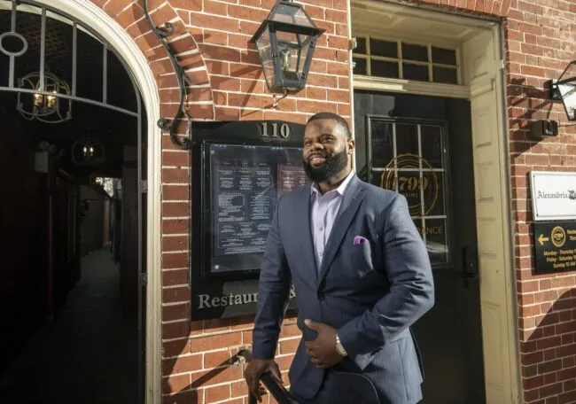 Jay Quander in front of 1799 Prime Steak & Seafood restaurant
