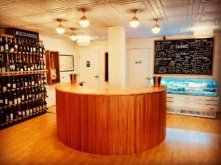 Guests enjoying wine tasting at an intimate indoor event venue
