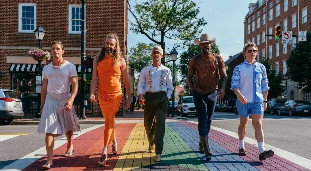 The cast of Queer Eye walking across a rainbow crosswalk in Alexandria, VA.