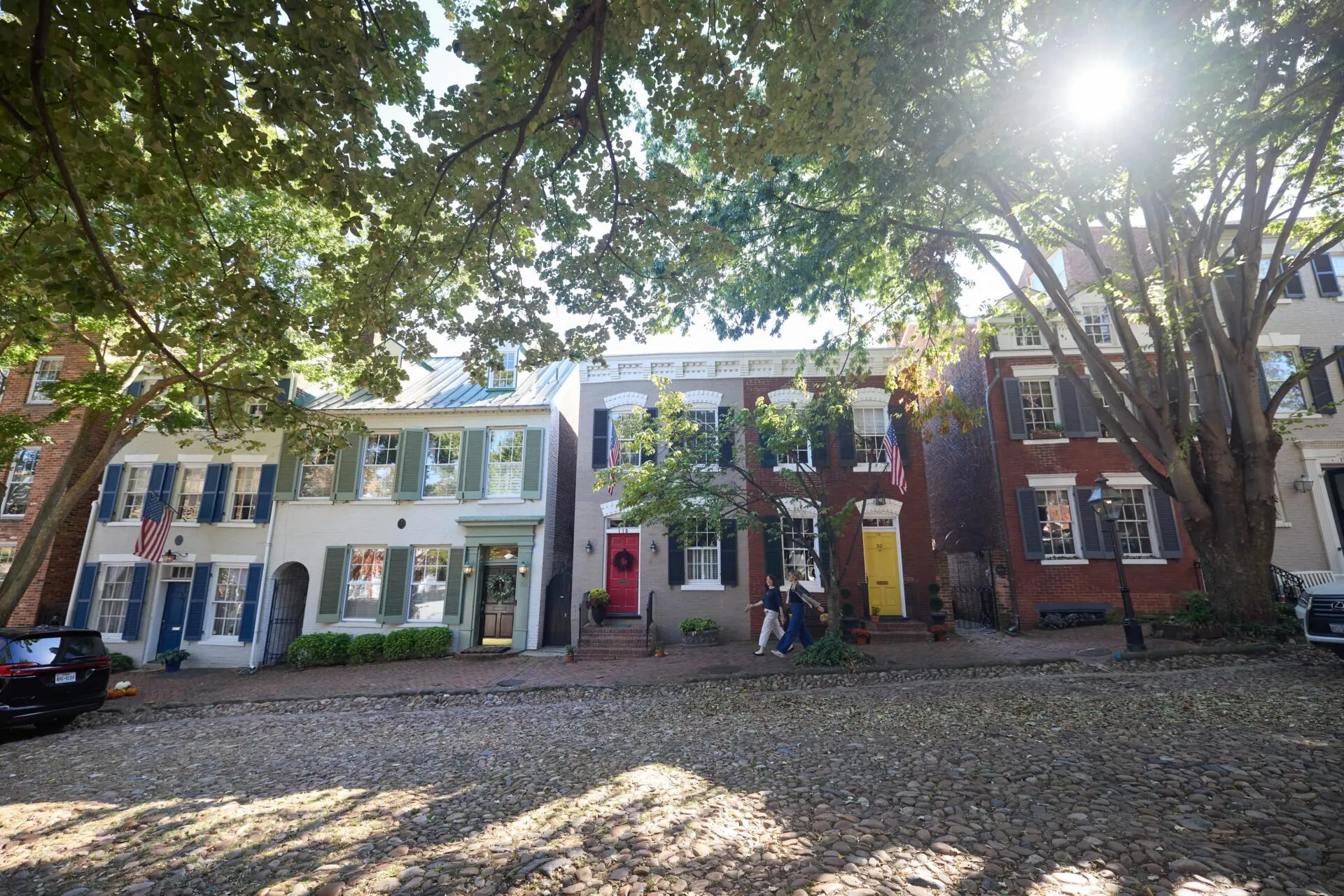 Colorful historic townhomes lining a cobblestone street in Old Town Alexandria.