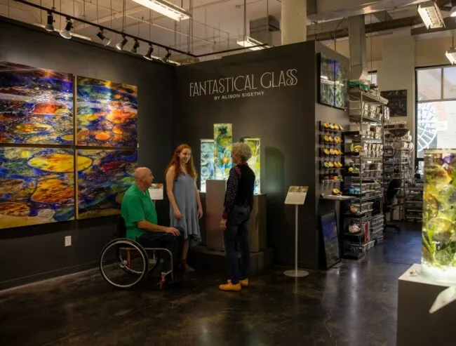 Visitors exploring Alison Sigethy’s Fantastical Glass exhibit inside Torpedo Factory Art Center.
