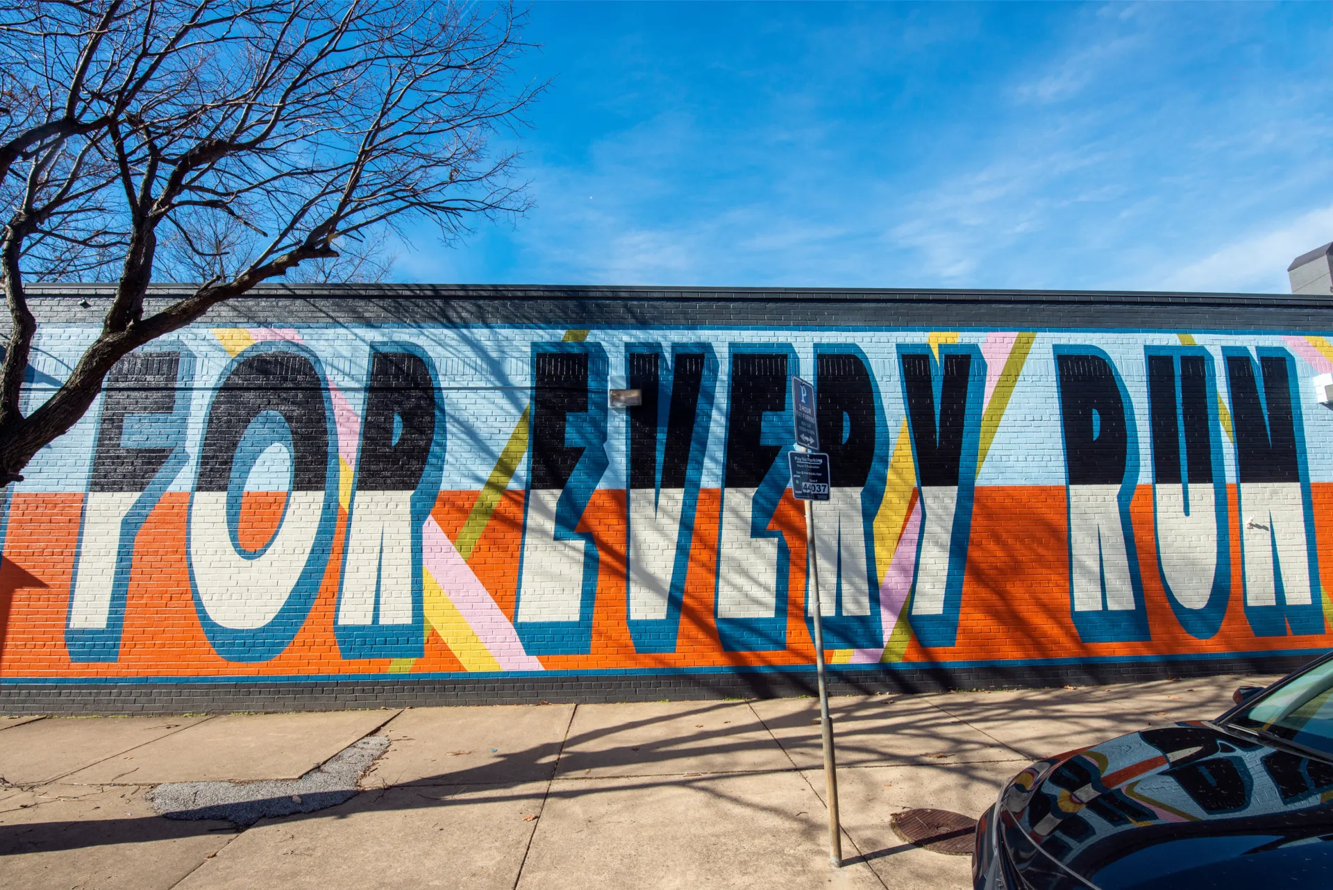 A colorful mural on the side of the Pacers Running shop in Old Town Alexandria reads 