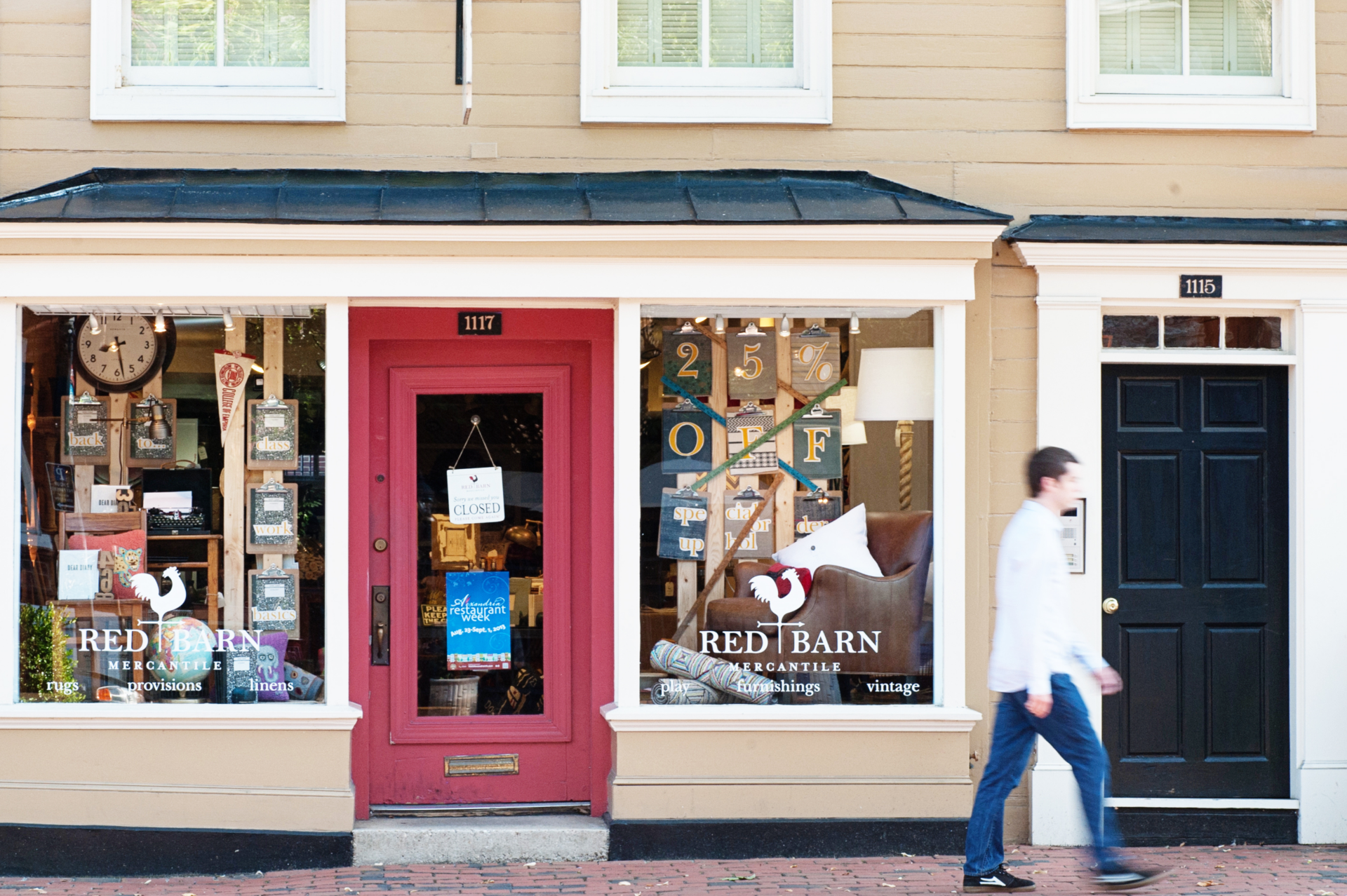 An image shows the exterior of Red Barn Mercantile, with a memorable red door, on Alexandria's King Street.