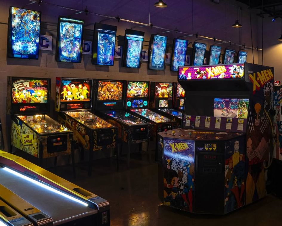A row of old-school pinball machines line up along a wall at Continues Arcade.
