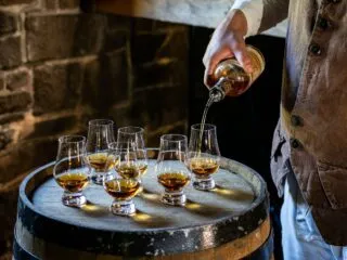 Visitors sample whiskey at George Washington themed tasting event