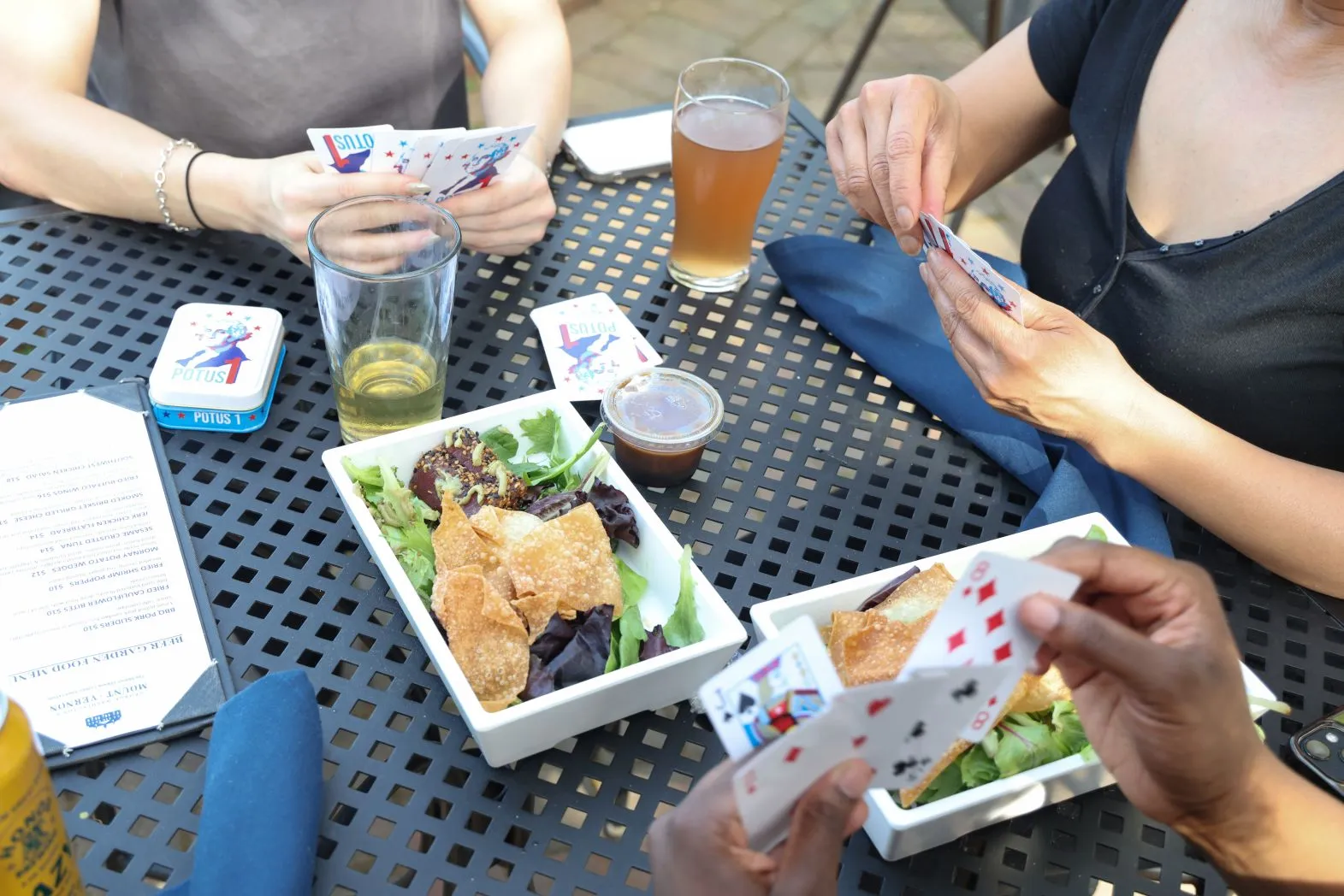 Customers playing cards and drinking beer at the Beer Garden at Mount Vernon Inn Restaurant.