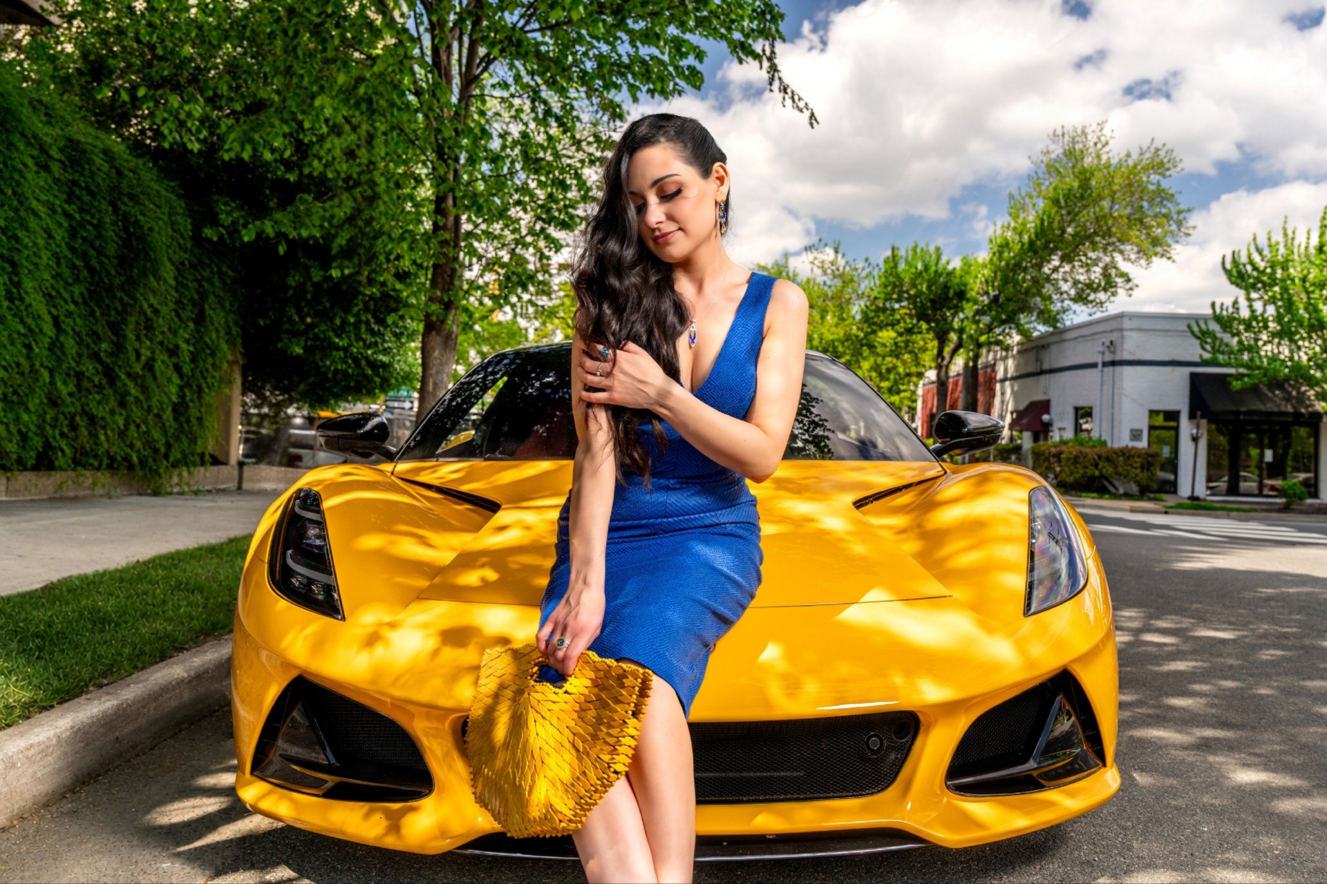 Ana Tkabladze posing in front of a bright yellow sports car for Old Town Festival of Speed & Style's 2026 style shoot gallery. 
