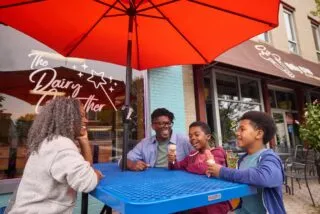 A family enjoys frozen custard at a table outside of Dairy Godmother in Alexandria's Del Ray neighborhood.