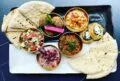 A plate of pita bread and various speads from Elaine's restaurant in Alexandria, VA.