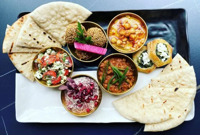 A plate of pita bread and various speads from Elaine's restaurant in Alexandria, VA.