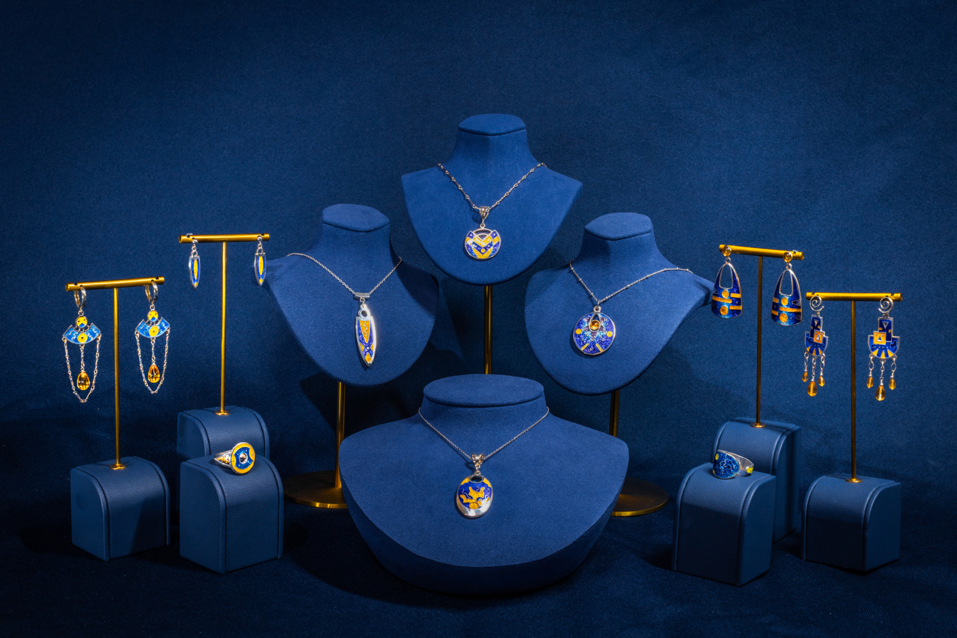 A wide collection of Ana's jewelry including neckleaces, earrings, and rings on display. 