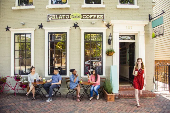 Customers seated outside Dolci Gelati enjoying ice cream.