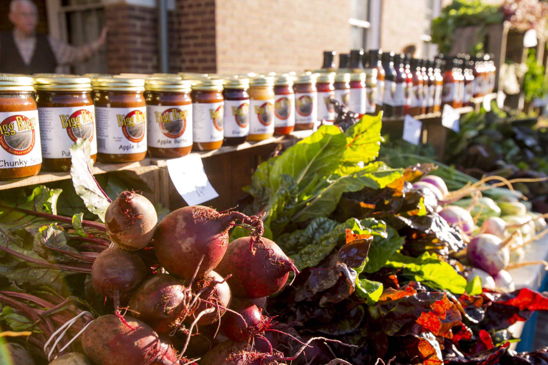 Close up image of fresh vegetables and jars at the Old Town Farmers Market.