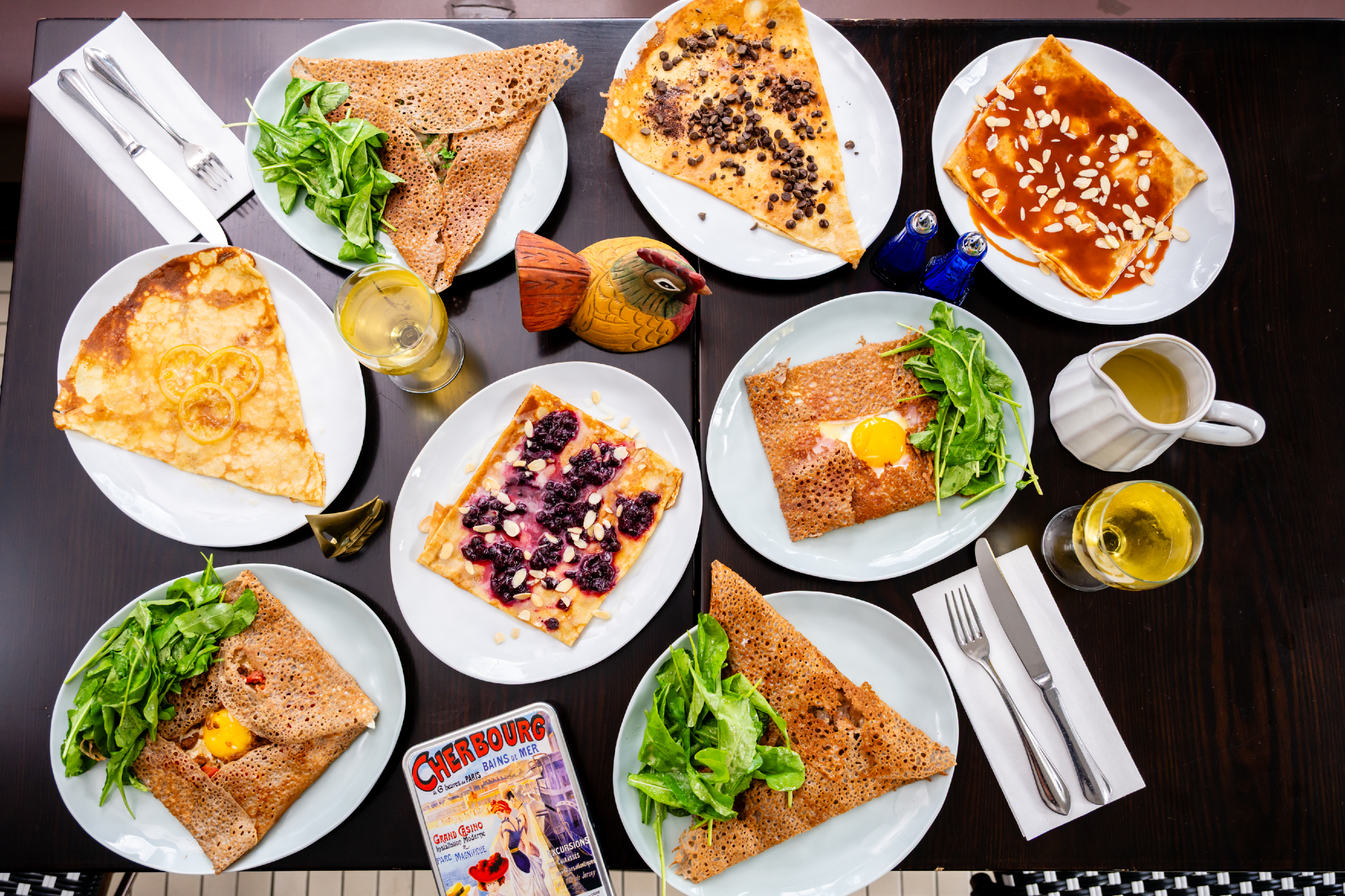A overhead view of various savory and dessert crepes served at Maison Breizh.