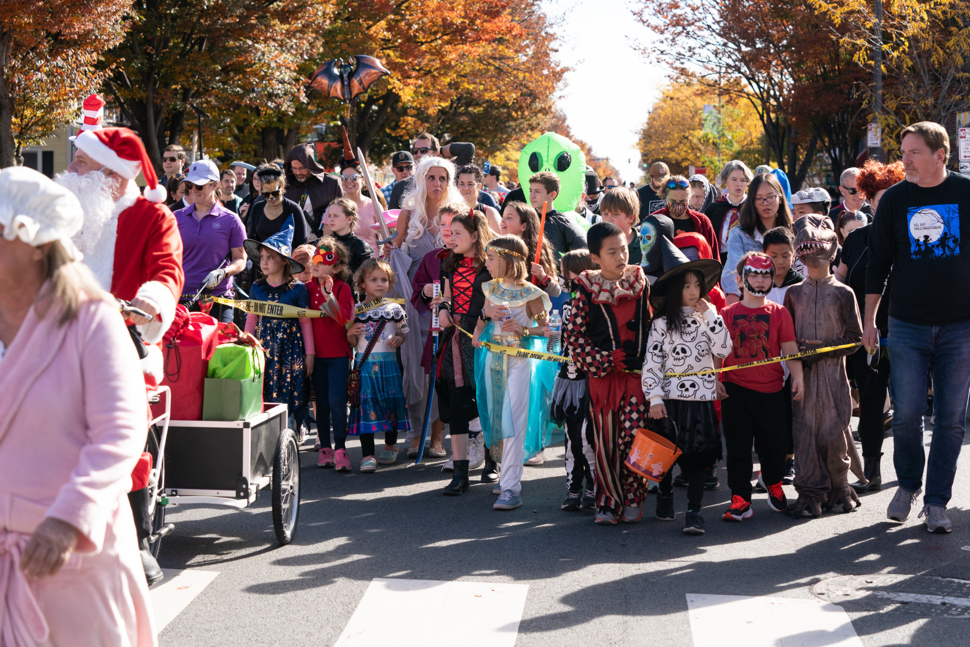 A group of people dressed in various costumes at the Del Ray Halloween parade.