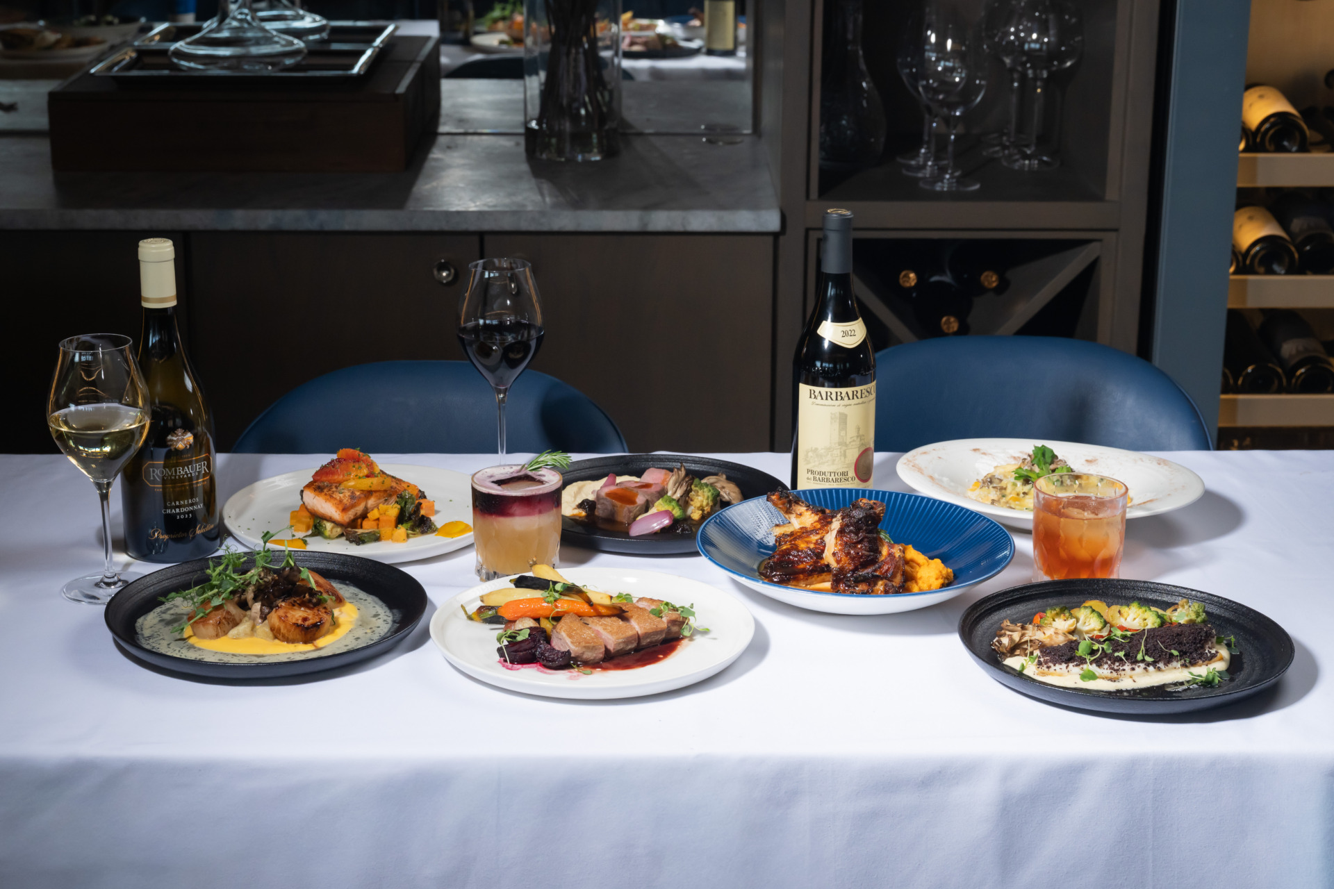 A wide variety of dishes served as part of Jula's on the Potomac's fall menu items on top of a white tablecloth. 