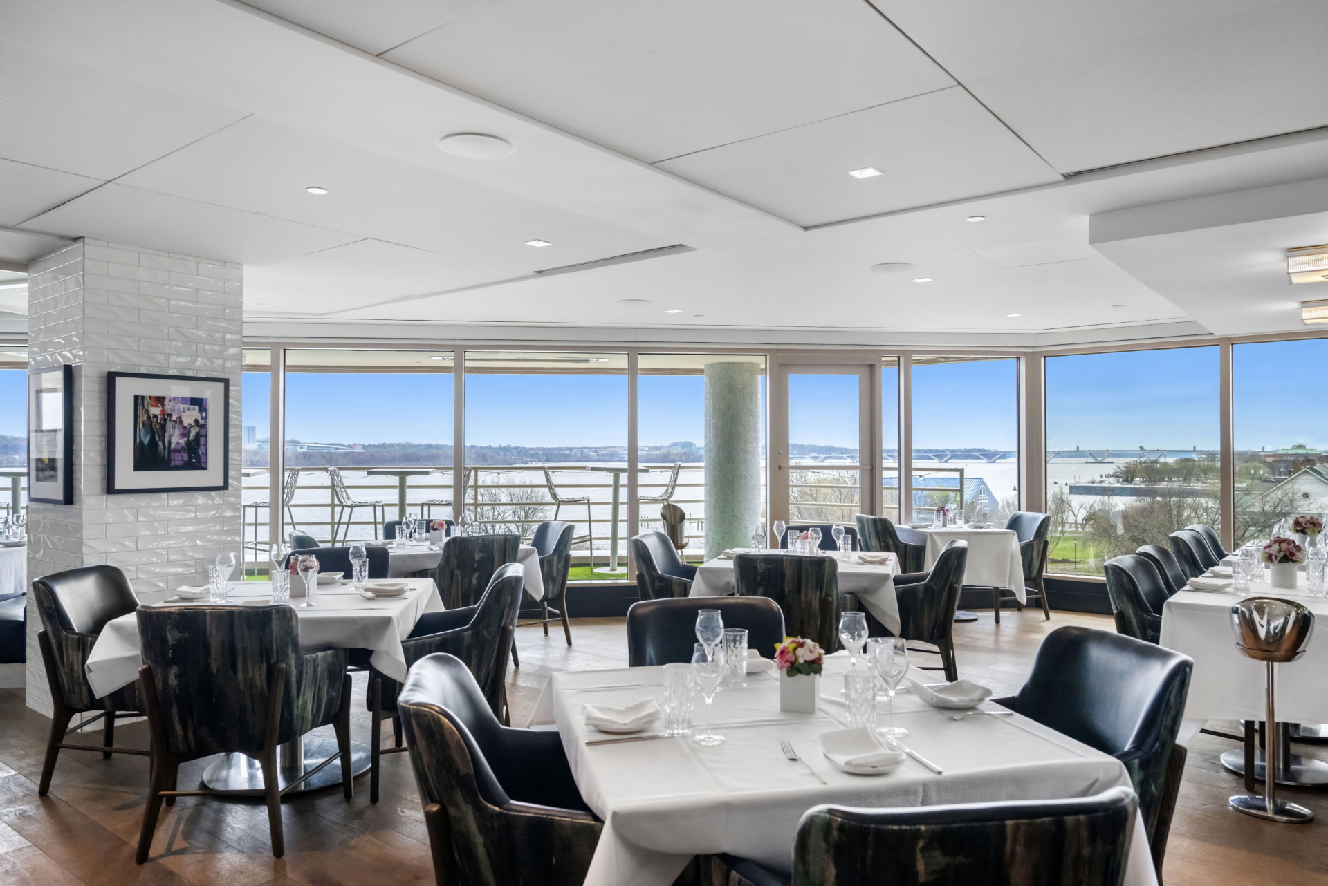 Inside the Veuve Lounge, wide windows show the Potomac River in the distance. 