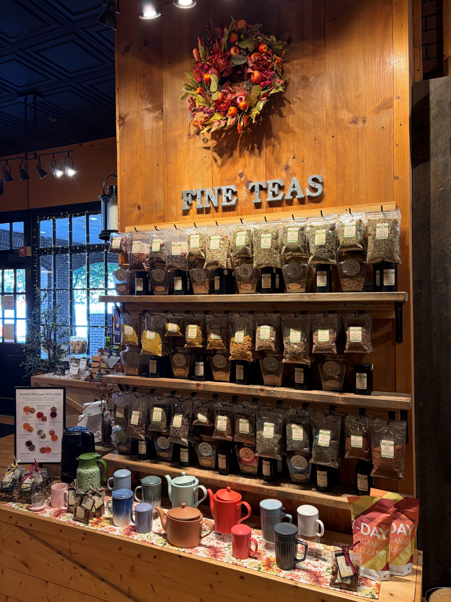 A wall of various types of teas in packets on a display wall.